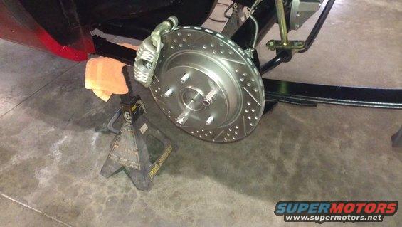 Rear brake rotor and caliper assembly on jack stands