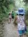 1992 Ford Explorer - A group enjoys a hike through a lush, green forest on a dirt path.