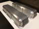 1972 Ford Ranchero - Two aluminum valve covers with a ribbed design are shown on a white surface.
