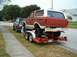 1979 Ford Bronco - A red and white 1979 Ford Bronco is seen being transported on a trailer, with another vehicle parked alongside.