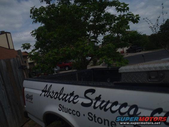 White 1997 Ford F-350 pickup truck side view with 'Absolute Stucco' decal