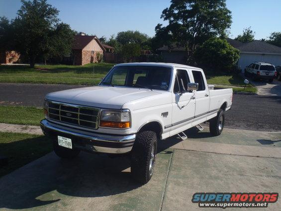 1997 Ford F-350 pickup truck parked in driveway, front 3/4 view