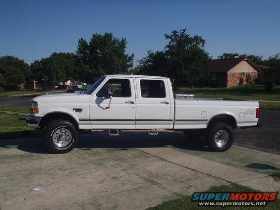 White 1997 Ford F-350 crew cab pickup truck parked on a driveway
