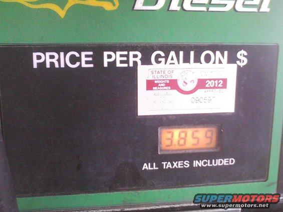 Gas pump display showing price per gallon of $3.859, with a 2012 Illinois Weights and Measures sticker