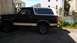 1993 Ford Bronco - Side view of a two-tone Ford Bronco, possibly a 1992 model, with a visible "SUPERMOTORS" watermark.