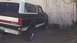 1993 Ford Bronco - Rear view of a 1993 Ford Bronco with two-tone paint and a red stripe.