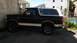 1993 Ford Bronco - This 1993 Ford Bronco is parked in an alleyway with buildings in the background.