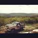 1995 Ford Bronco - Off-roading in a vintage Ford Bronco on a scenic, hilly terrain.