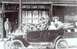 1912 Ford Model T - A family poses in their 1912 Ford Model T outside a United Cigar Stores Co. establishment.