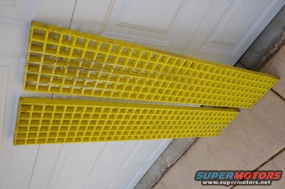 Two yellow plastic sand tracks with a grid pattern