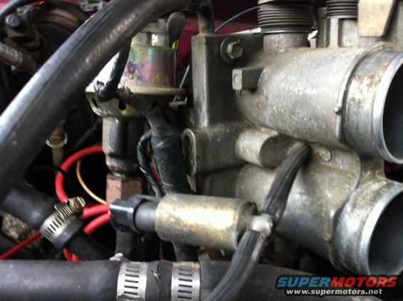 img_0694.jpg Disconnect the rubber hose running to the throttle body from this solenoid. I cannot remember its name. While you are there disconnect the coolant lines running to the throttle body. There should be two. One at the top from the radiator and one at the bottom from the thermostat housing (I think). Also unbolt the EGR from the throttle body. You can unbolt it from the exhaust manifold, but you might run into issues there.