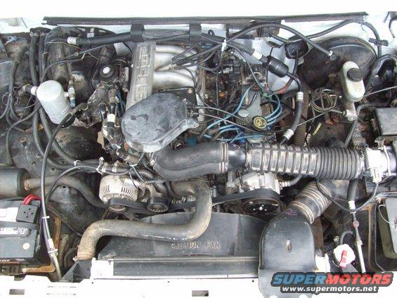 Engine bay with visible "CAUTION FAN" text