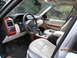 2008 Land Rover Range Rover - The interior of a luxury SUV features white leather seats and wood accents. A date stamp indicates the photo was taken on March 22, 2012.