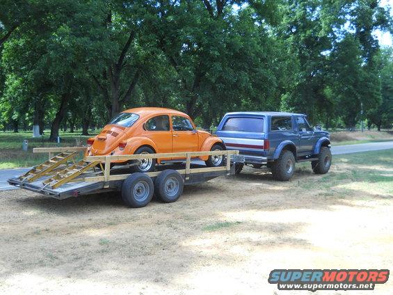1992 Ford Bronco towing trailer with orange VW Beetle