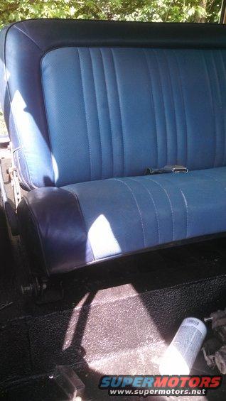 Blue vinyl seat with dark blue trim and seatbelt