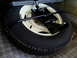1963 Ford Fairlane - Spare tire and jack assembly secured in the trunk of a vehicle.