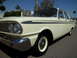 1963 Ford Fairlane - Cream-colored 1963 Ford Fairlane sedan parked on asphalt under a clear blue sky.