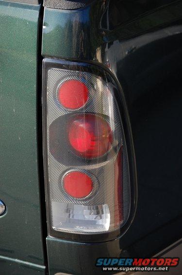 Close-up of a green truck's rear tail light assembly