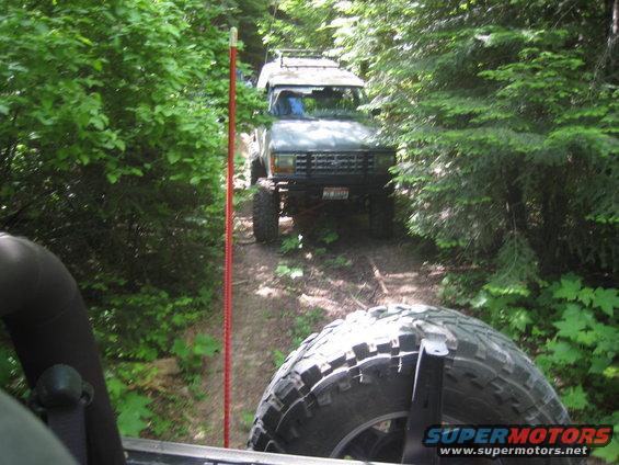Off-road vehicle on a dirt path, front view