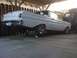 1964 Ford Ranchero - Rear view of a white 1964 Ford Ranchero pickup truck, elevated on jack stands in a garage.