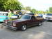 1972 Ford Ranchero - A maroon and tan Ford Ranchero is parked at an outdoor car show with other vehicles present.