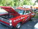 1972 Ford Ranchero - This red Mercury Comet, likely a 1966 model, is displayed with its hood open, revealing the engine and race-inspired graphics.