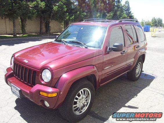 Red Jeep Liberty with chrome wheels