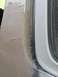 1996 Ford Bronco - Close-up of body filler application on a vehicle's door frame, with the Supermotors.net logo in the corner.