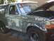 1996 Ford Bronco - This 1996 Ford Bronco is in the process of repair, with its hood up and bodywork visible.