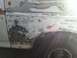 1996 Ford Bronco - This vehicle's bodywork is undergoing repairs, with visible filler and primer applied to the side panel.