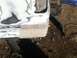 1996 Ford Bronco - The rear quarter panel of a 1996 Ford Bronco is undergoing bodywork, with visible primer and filler.