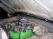 1979 Ford Bronco - The engine bay of a vehicle, a bright green V8 engine with aftermarket parts.