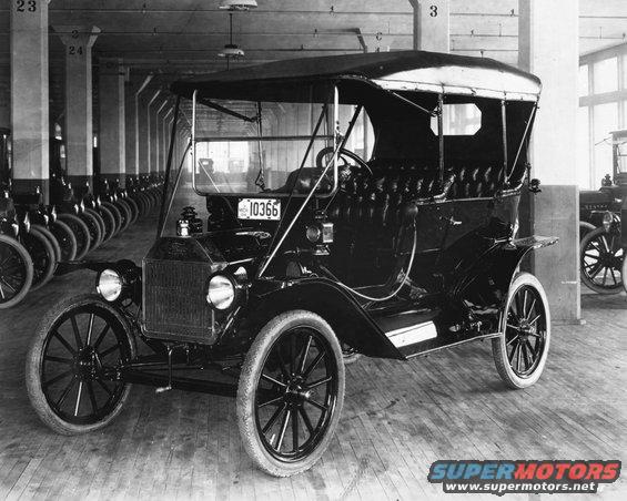 Black 1909 Ford Model T touring car with a soft top, viewed from the front three-quarter angle