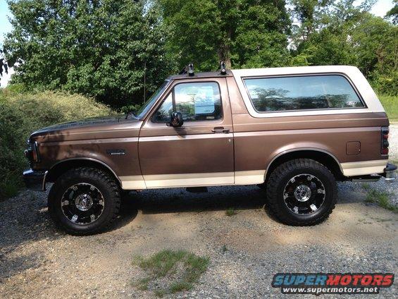 Brown 1993 Ford Bronco side view with aftermarket wheels