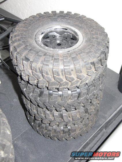 stack of four off-road tires with aggressive tread