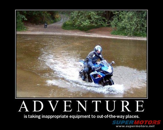 Blue sport motorcycle riding through water, another motorcycle in background