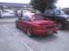 2003 Ford Crown Victoria - A red Toyota MR2 and a black pickup truck are parked at a gas station.