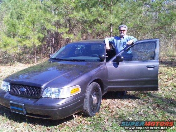 2004 Ford Crown Victoria, dark gray, 3q front view with driver's door open