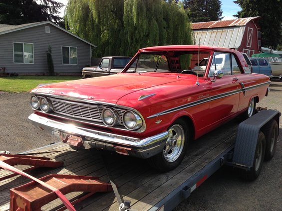 Red 1964 Ford Fairlane convertible on a trailer, front 3/4 view