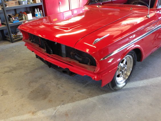 Red 1964 Ford Fairlane front end with chrome trim and exposed grille