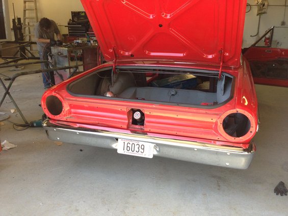 1964 Ford Fairlane rear with trunk open, showing empty interior. License plate reads 16039