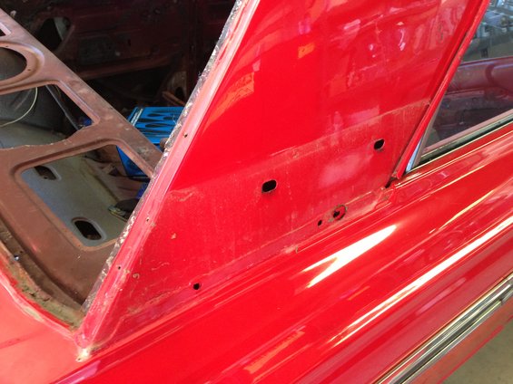 Red car interior with open trunk area and chrome trim
