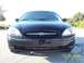2003 Ford Taurus - Front view of a black 2003 Ford Taurus sedan parked outdoors.