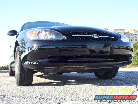 Front view of a black Ford sedan, showing the grille and headlights. Date stamp reads 11/26/2003