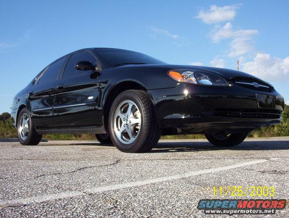 Black 2003 Ford Taurus sedan, front 3/4 view, parked on asphalt