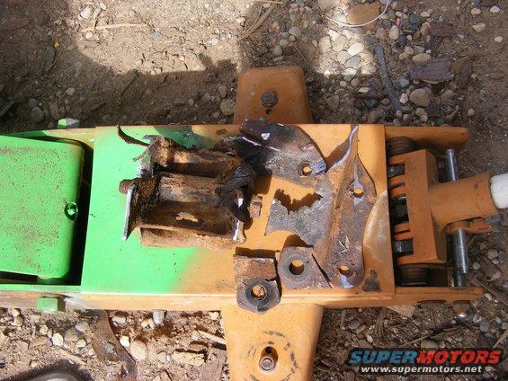rusted metal bits and pieces on top of an orange and green jack