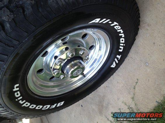 Close-up of a BFGoodrich All-Terrain T/A tire on a shiny chrome wheel with a center cap