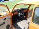 1992 Ford Bronco - Interior view of an orange Volkswagen Beetle, showing custom steering wheel and shifter.