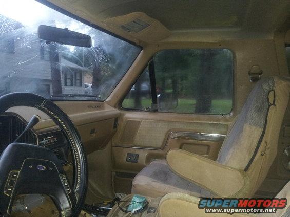 1988 Ford Bronco interior showing tan seats, dashboard, and steering wheel