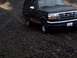 1994 Ford Bronco - This 1994 Ford Bronco is captured in a 3q-front view, navigating a rough, rocky landscape.